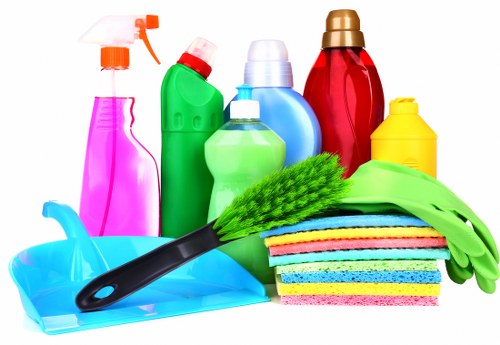 Cleaner preparing a safe home cleaning workspace