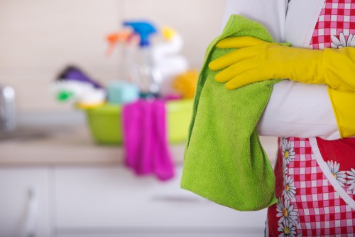 Cleaner in Cleaninghome sanitizing a kitchen surface